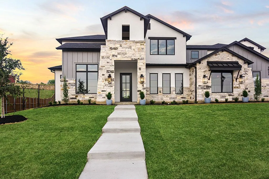 Modern two-story house with stone facade.